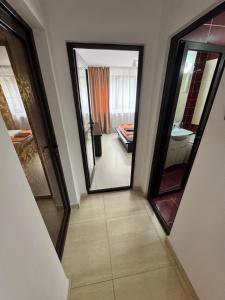 a hallway with two large mirrors and a bathroom at HomeLand3 in Bîrlad