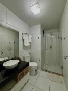 a bathroom with a sink and a toilet and a shower at Iloa resort AP luxo in Barra de São Miguel