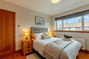 a bedroom with a bed and a large window at Blue Crab House - Tynemouth in Tynemouth