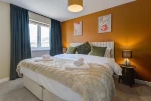 a bedroom with a large bed with towels on it at Marriott House sleeps 5 in Bourne with parking in Bourne +26 photos