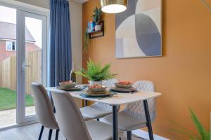 a dining room with a table and chairs at Marriott House sleeps 5 in Bourne with parking in Bourne