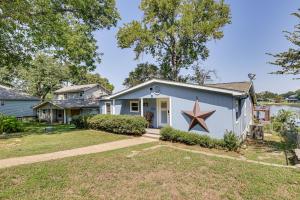 a house with a star painted on the side of it at Lakefront Escape with Game Room and Dock in Mabank! in Enchanted Oaks