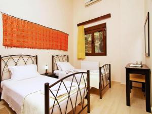 a bedroom with two beds and a table and a window at Holiday home with pool in Kalamítsion Alexándrou +21 photos