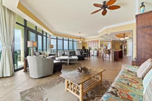 a living room with a couch and a table at Phoenix West 2601 in Orange Beach