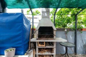a outdoor grill with a chair and a table at Apartmani LUNA in Vir