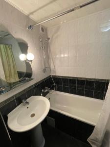 a bathroom with a sink and a bath tub at Apart Center in Sumy