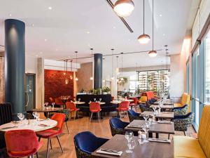 a dining room with tables and chairs and a restaurant at Sofitel Brussels Europe in Brussels