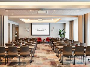 a room with rows of tables and chairs at Sofitel Brussels Europe in Brussels