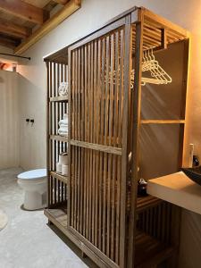 a wooden cage in a bathroom with a toilet at Maison de Reve - Boutique Guest House in Brisas de Zicatela +59 photos