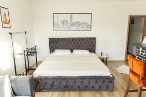 a bedroom with a large bed in a room at Infinit Apartment in Prishtinë