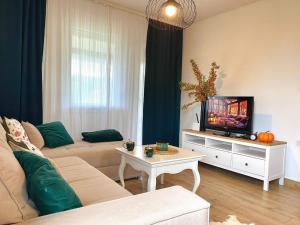 a living room with a couch and a tv at Košutica Vila in Koraćica