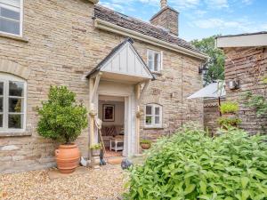 a brick house with a white door and a yard at 1 Bed in Newton St Margarets 93134 in Bacton