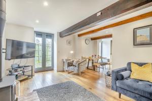 a living room with a couch and a tv at Swallows Barn in Little Snoring