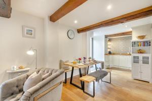 a living room with a couch and a table at Swallows Barn in Little Snoring