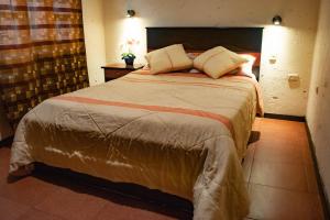 Postel nebo postele na pokoji v ubytování Hostal Cielo