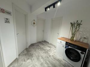 a laundry room with a washing machine in it at Daly Residence in Buzău +5 photos