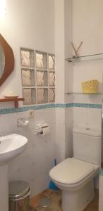 a bathroom with a white toilet and a sink at 'La Casa de LoLa' casita de cuento con vistas in Arenas de San Pedro +36 photos
