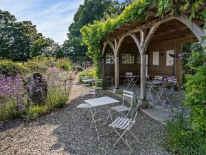 a group of chairs and tables in a garden at 2 Bed in Kington 92986 in Lyonshall