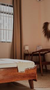 a bedroom with a bed and a window and a table at Cocohut Zanzibar - Kendwa & Nungwi in Kendwa +39 photos