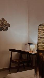 a desk with a lamp and a chair in a room at Cocohut Zanzibar - Kendwa & Nungwi in Kendwa