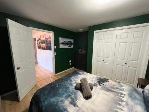 a bedroom with green walls and a large bed at Lake View Suite, Forest Retreat, Balfour BC in Balfour +5 photos