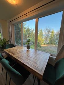 a table in a room with a large window at Lake View Suite, Forest Retreat, Balfour BC in Balfour