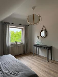 a bedroom with a bed and a table and a window at Ferienwohnungen Archie oder Lilli,Nähe Europa Park, Strasbourg, Schwarzwald in Schutterwald