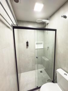 a glass shower in a bathroom with a toilet at FLAT CAMBUCI - Hospedagem e Moradia - Centro de Ipiaú-BA in Ipiaú +11 photos