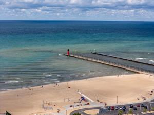 an aerial view of a beach with a pier and the ocean at Lux Beach Home Lake Views Firepit in South Haven +63 photos