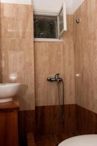 a bathroom with a shower and a toilet and a sink at Miltiadis Apartments in Ambelas +67 photos