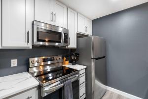 a kitchen with a stainless steel refrigerator and a microwave at Top Notch - Condo for 6 in Branson +22 photos