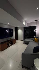 a bedroom with a bed and a flat screen tv at Distrito Chapultepec in Guadalajara