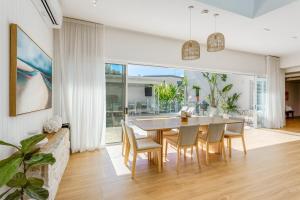 Un comedor con mesa y sillas en Luxury Dream Home Away From Home&heated pool, en Deception Bay