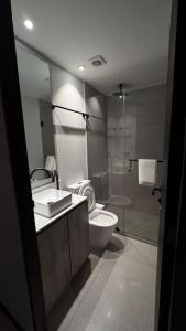 a bathroom with a toilet and a sink and a shower at Distrito Chapultepec in Guadalajara +15 photos