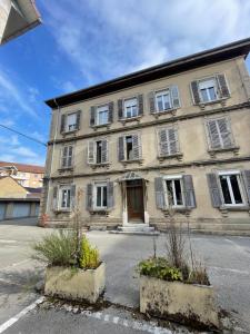 a large building with windows and a door at Appart' Porte Saint-Pierre in Pontarlier