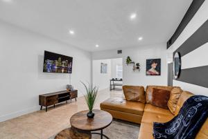 a living room with a couch and a table at Luxury Miami Home Close to Beach & Aventura Mall in Biscayne Park