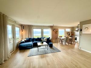 a living room with a blue couch and a table at Top location - Amazing views in Tromsø