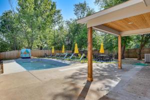 a pool with a pavilion and chairs and umbrellas at 12 Mi to BOK Center Pet-Friendly Home with Yard! in Union