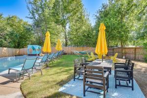 a group of tables with umbrellas next to a pool at 12 Mi to BOK Center Pet-Friendly Home with Yard! in Union