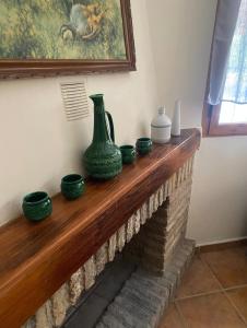a fireplace with green vases on top of it at Casa Rural Mirador de la Tinajuela a menos de 20 minutos de Andújar in Andújar