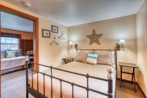 a bedroom with a bed and a mirror at Hidden Villa Cottage #6 - The Starfish Cottage in Cannon Beach