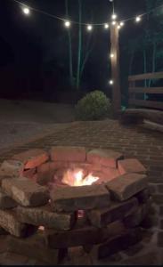 a fire pit in a brick yard at night at Recanto Nascer do Sol in Nova Petrópolis