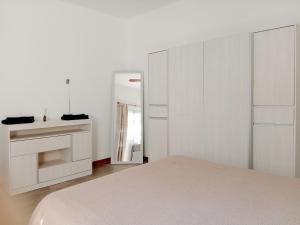 a white bedroom with a bed and a fireplace at Casa Avellaneda in Santa Fe