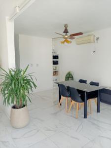 a dining room with a table and chairs and a plant at Casa Avellaneda in Santa Fe +5 photos