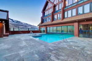 una casa con piscina delante de un edificio en The Lodge at Mountain Village Unit 308A, en Park City