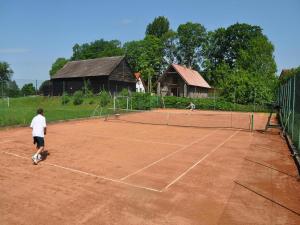 two people playing tennis on a tennis court at Holiday home with fireplace and private garden in Grąbczyn