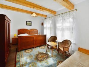 a bedroom with a bed and a table and chairs at Holiday home with fireplace and private garden in Grąbczyn