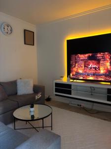 a living room with a large flat screen tv at Heavenly Home in Cape Town