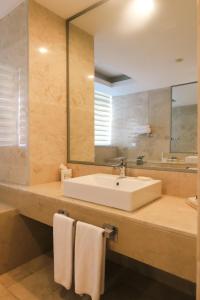 a bathroom with a sink and a mirror at Qafqaz Baku Residence &Apartment in Mekhrably