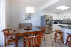 a kitchen with a table and chairs and a refrigerator at Phoenix VI 61507 in Orange Beach